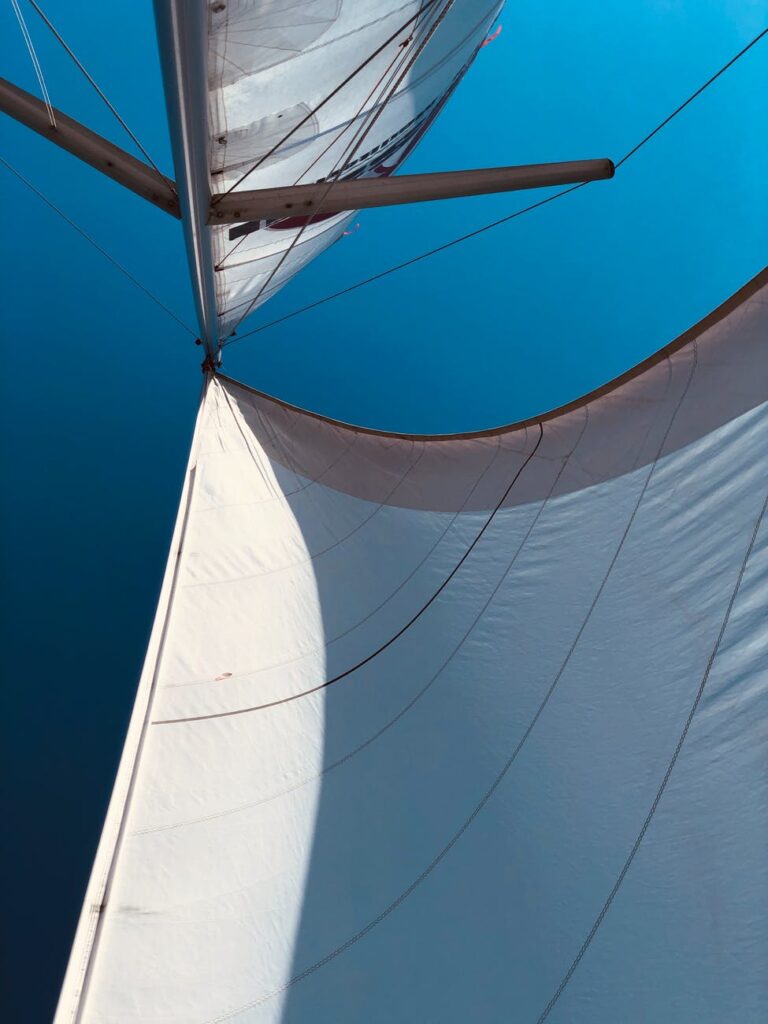mainsail of a sailboat under blue sky