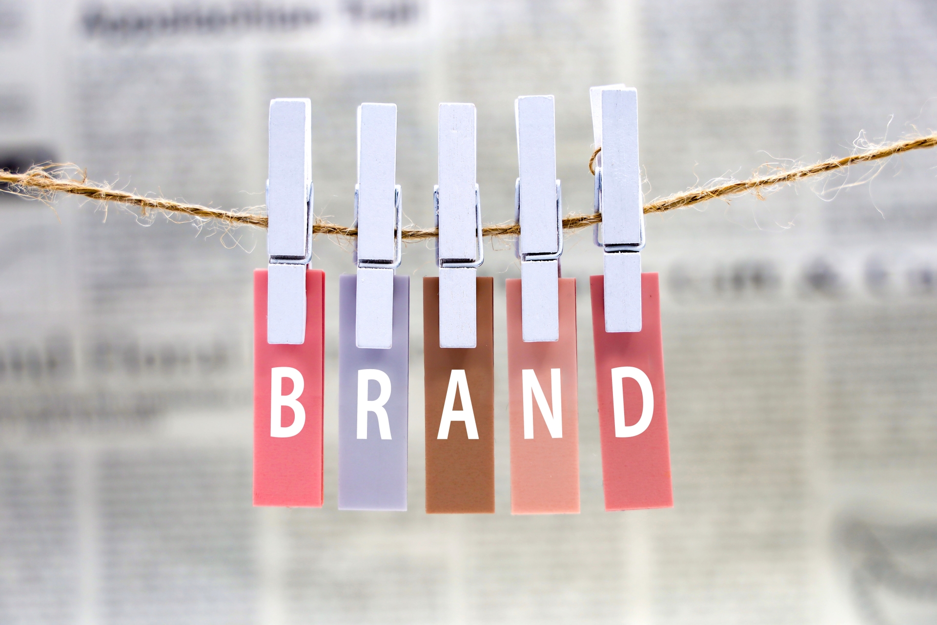 洗濯ばさみで吊るされたカラフルなカードに「BRAND」の文字が並ぶ画像