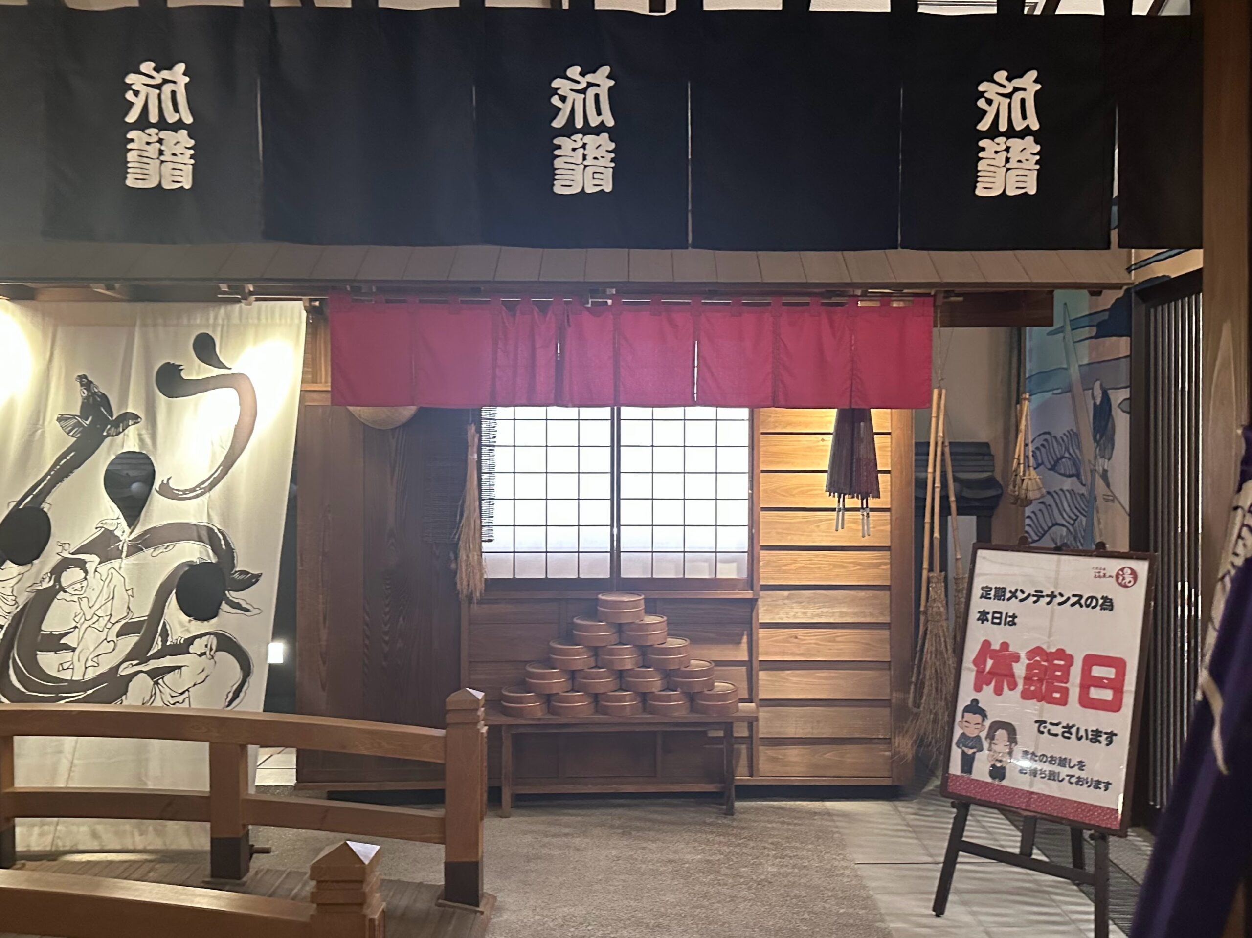 和風の内装と赤い暖簾が特徴的な温浴施設の休館日入口