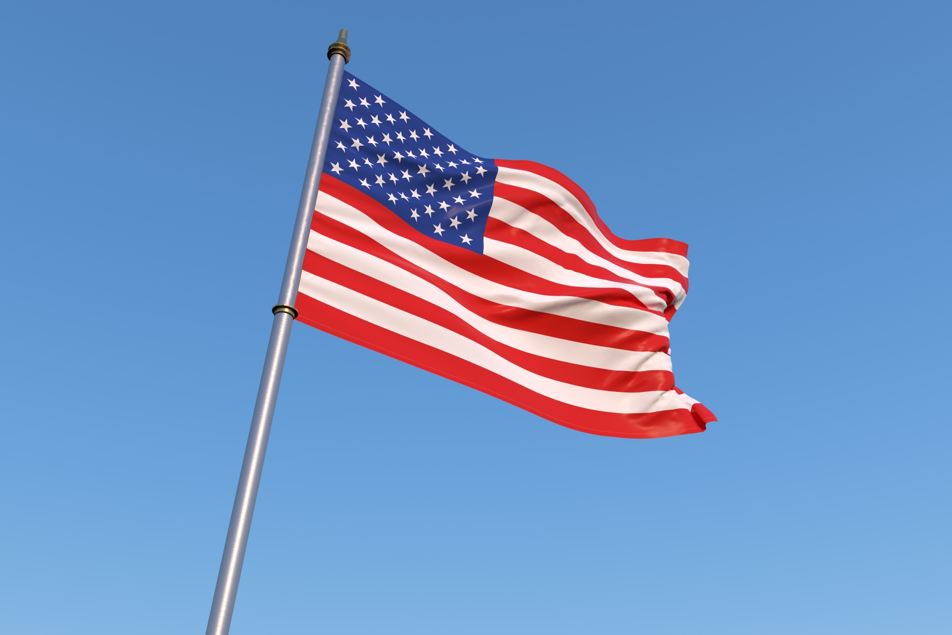 青空の下で風にたなびくアメリカ合衆国国旗
