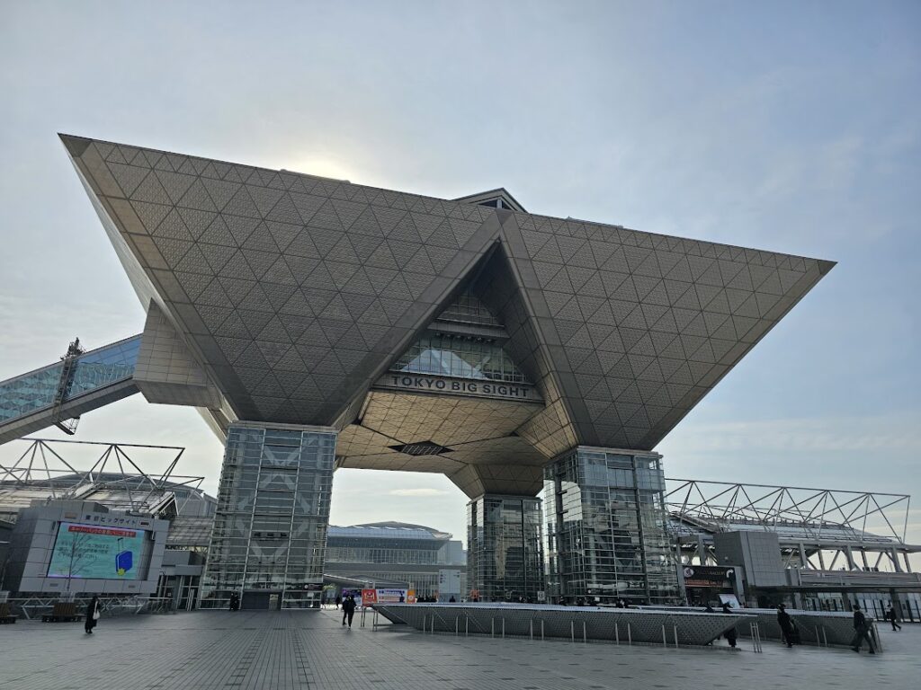 東京ビッグサイト正面入口の逆三角形構造と広場の様子を撮影した展示会会場外観の写真です。