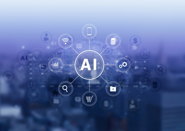 青い背景にAIという文字を中心としたアイコンが円状に広がりネットワークを形成しているイメージ画像